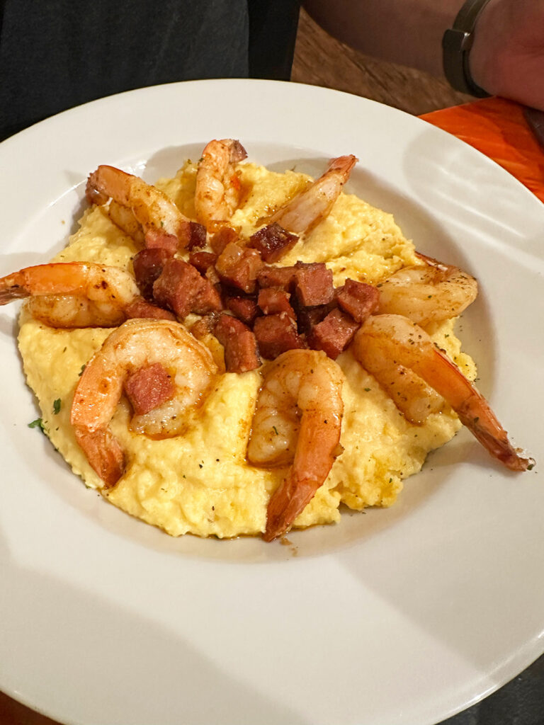 view of yellow grits with cooked shrimp on plate