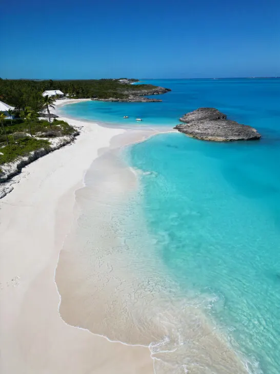 beautiful aerial photo of white sand beach with two coves and coastline visit Exuma Bahamas