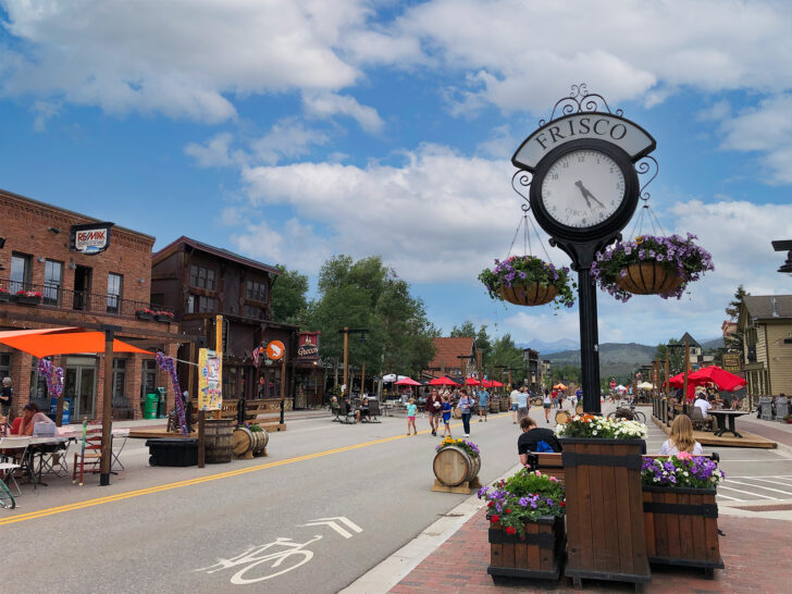 downtown Frisco Colorado with shops restaurants and clock that says Frisco on it