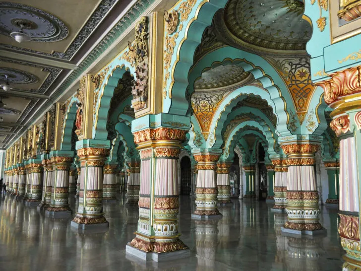 beautiful ornamental palace walls on a bucket list trip to India with teal, pinks and gold colors