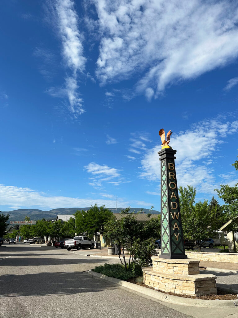 large pillar in street that reads Broadway