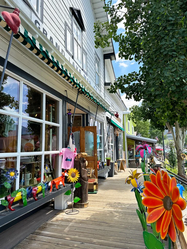 shop and boardwalk with items out front and flowers