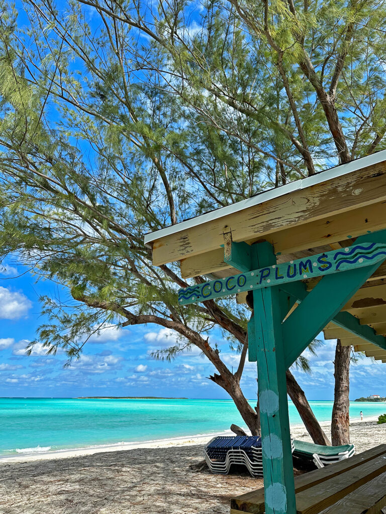 view of beach an diner with sign that says coco plums