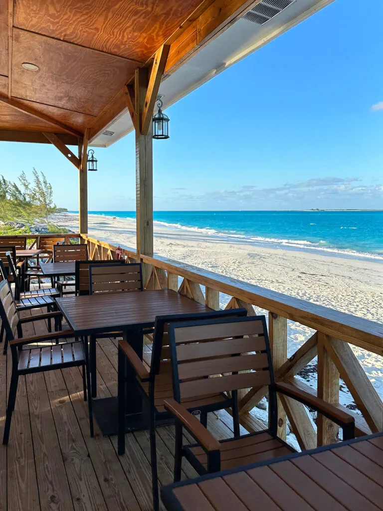 restaurant tables with beach in distance in Exuma Bahamas