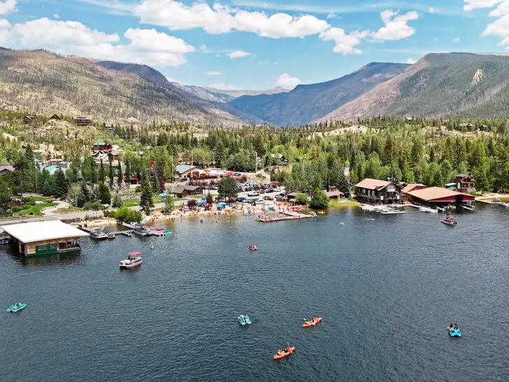 Grand Lake Colorado mountain town from above with kayaks in water and shoreline with mountains underrated travel destinations