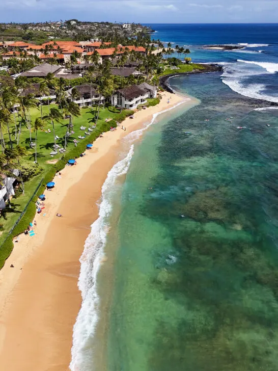 beautiful kauai photos with view of gold sand beach teal water and coastline