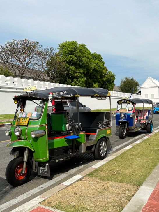 two tuk tuks on street in thailand