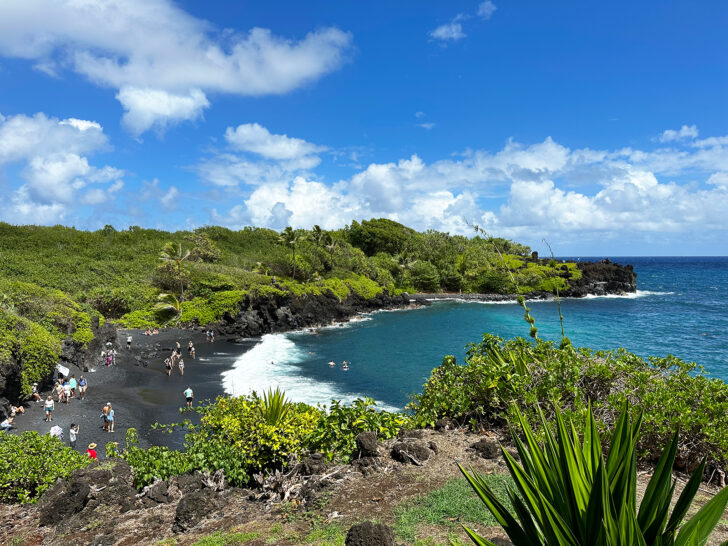 blue sky with green coast and black sand beach Wai'anapanapa State Park