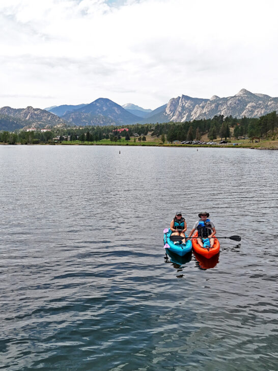 two kayaks on lake Estes Colorado with mountains in distance