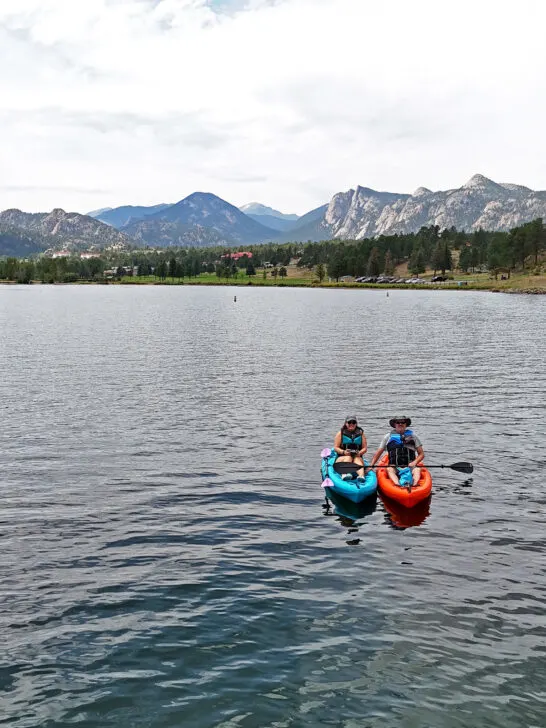 two kayaks on lake Estes Colorado with mountains in distance