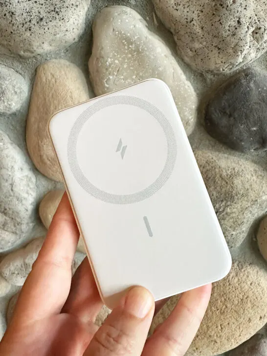 white wireless phone charger against a stone wall