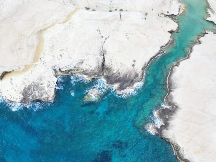 can you fly a drone with aerial internationally view of blue water and white rocky formations