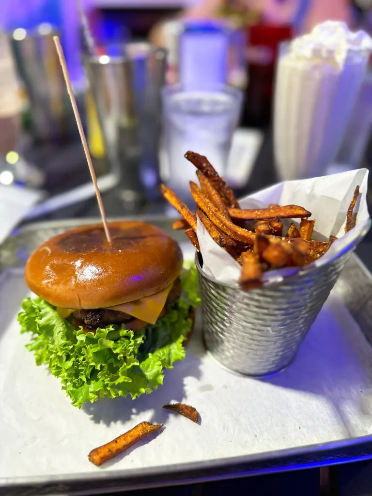 view of cheeseburger and French fries on tray