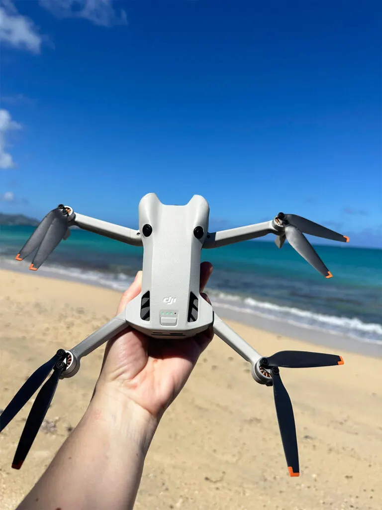 dii mini 4 pro drone hand holding with ocean in distance best travel drones