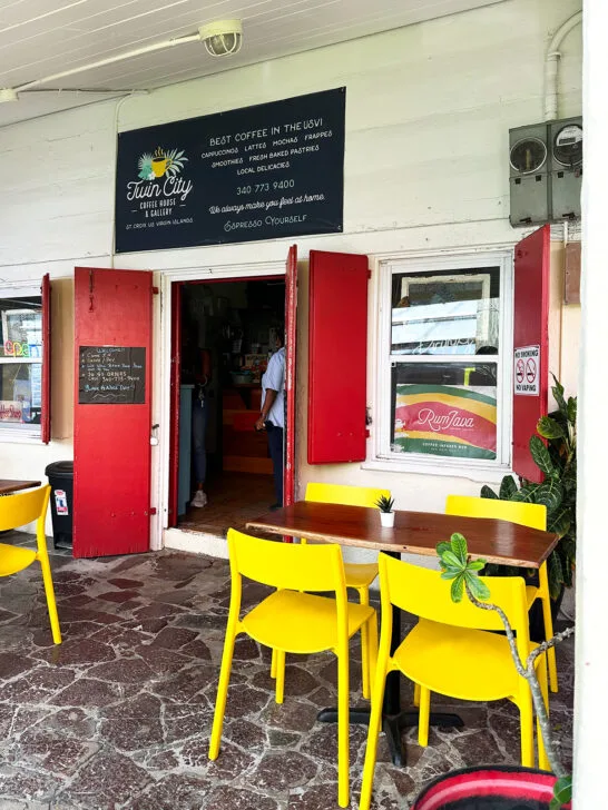 yellow chairs at outside table with restaurant entrance sign that says twin city