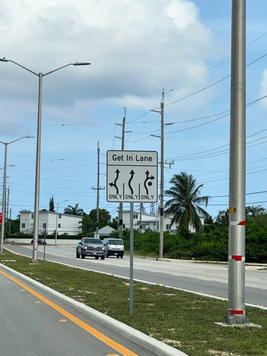 visiting Cayman Islands view of street sign with roundabout lanes