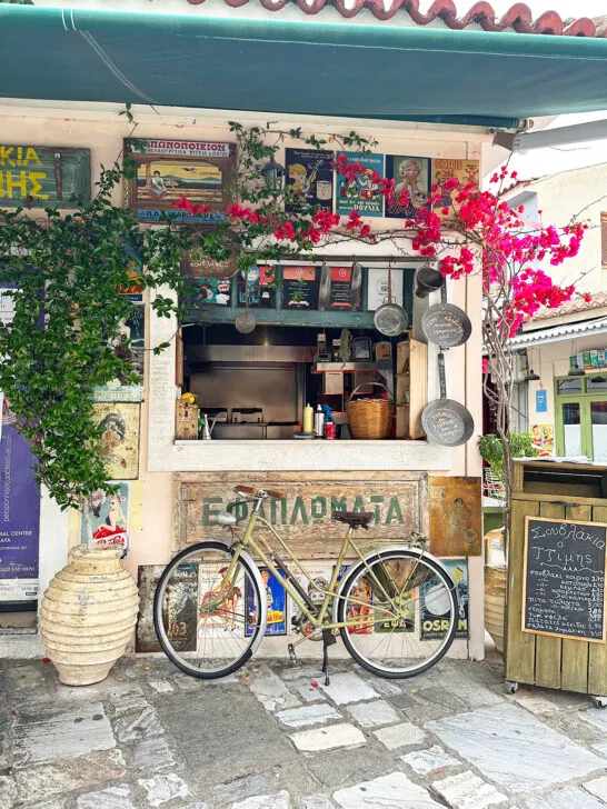 view of greece shop front with flowers signs and bicycle