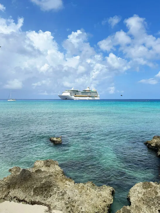 Cayman Island tips view of cruise ship off the coast with bright blue water
