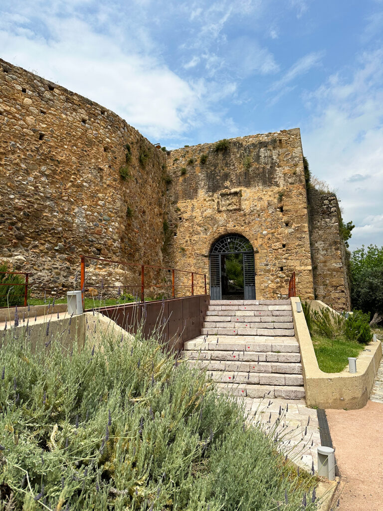 view of steps leading to old walls of castle with blue sky