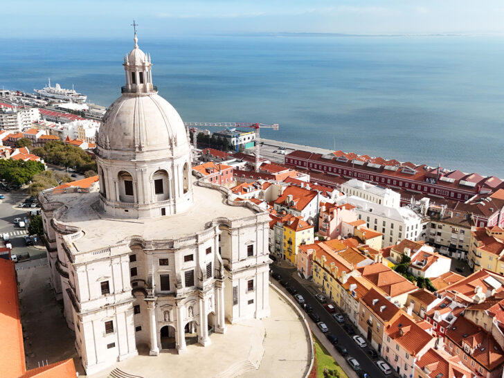 3 days in Lisbon itinerary aerial view of white building with orange rooftops and blue water