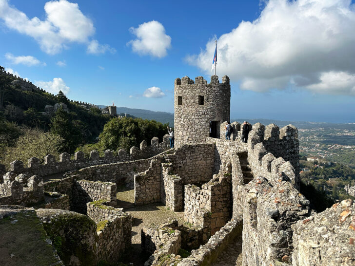 view of the Great Wall of Portugal with stone exterior with blue sky day trip from Lisbon Portugal