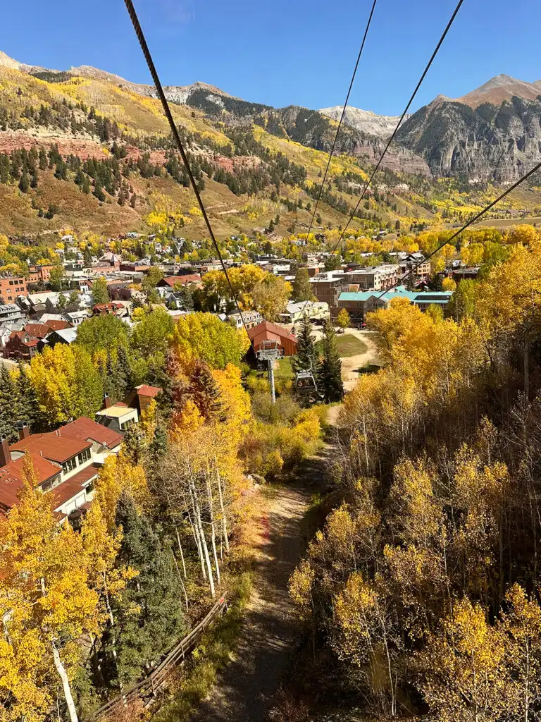 view of mountain town with brightly colored fall foliage