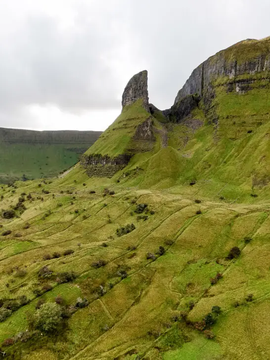 jagged rock with green countryside in ireland