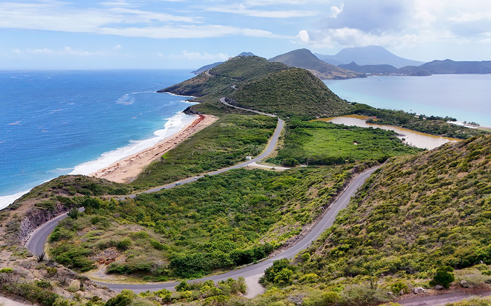 view of Saint Kitts ocean and mountains with road curving through it